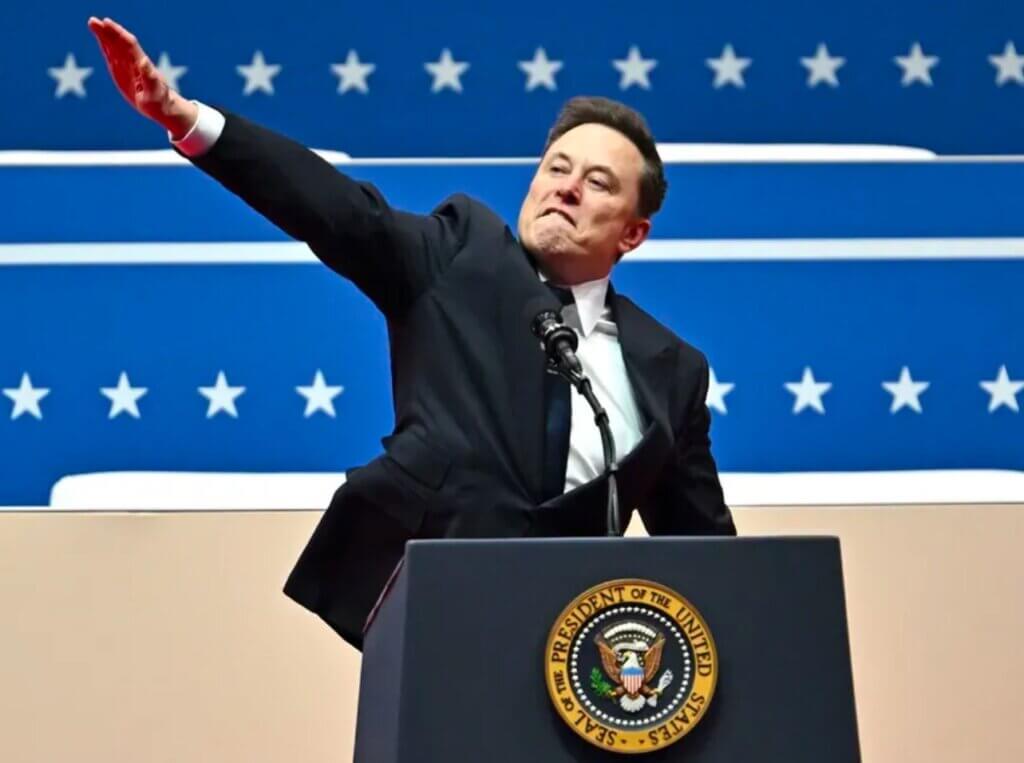A man in suit and tie at podium with arms raised.